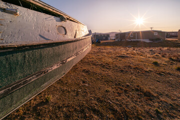 An old wooden boat in Inuit community of Qikiqtarjuaq, Broughton Island, Nunavut, Canada. Settlement in the far north. Arctic community.