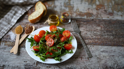 Healthy salad rucola cherry tomatoes and flaxseeds. Healthy diet.