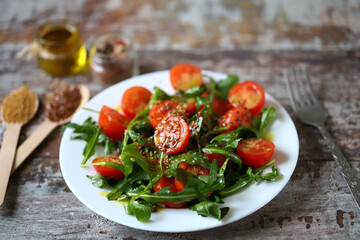 Healthy salad rucola cherry tomatoes and flaxseeds. Healthy diet.