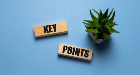 Key point on wooden cube on the background of a working man at a computer. Business success measurement goal and goal management concept.