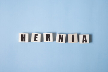 Hernia - words from wooden blocks with letters, medical condition hernia concept, white background