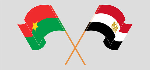 Crossed and waving flags of Burkina Faso and Egypt