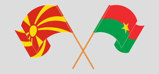 Crossed and waving flags of North Macedonia and Burkina Faso