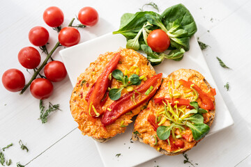 vegan roasted red pepper dip sandwich spread on freshly baked bread slice with salad garnish on white porcelain plate 