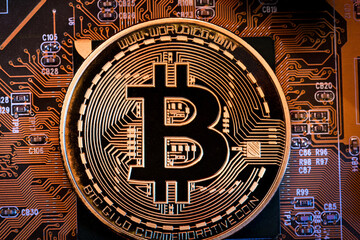Fototapeta na wymiar Bitcoins on the motherboard. Crypto currency Gold Bitcoin - BTC - Bit Coin on colorful background
