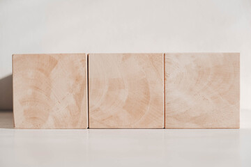 Wooden cubes from natural wood on a white background. Copy, empty space for text