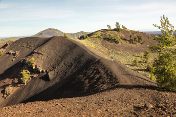 USA, Idaho, Craters of the Moon National Monument and Preserve. Hiker on North Crater Trail. © Danita Delimont