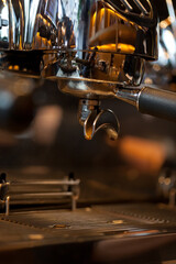 closeup of double spout portafilter holder in espresso machinge group head