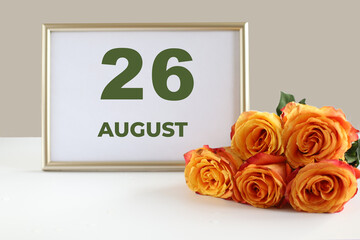 Day of the month calendra photo frame and yellow rose on the table