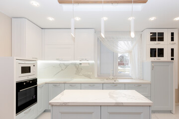Beautiful view on white kitchen with window.