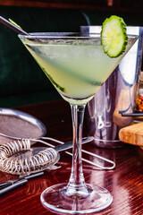 Cucumber martini cocktail on wooden table
