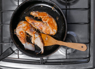 Salmon steak is cooked in a pan