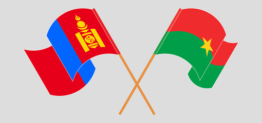 Crossed and waving flags of Mongolia and Burkina Faso