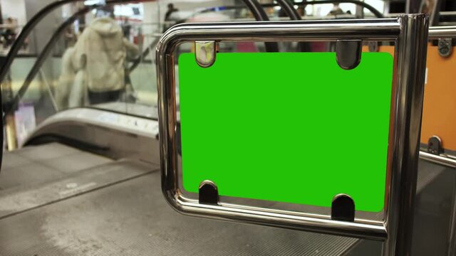 Billboard with a green screen. Escalator bounding barrier with copy space.