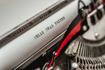 Text Hello dear friend old school style printed on retro vintage typewriter machine. Word concept...