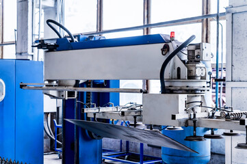 Close up of machine for loading sheet metal in factory