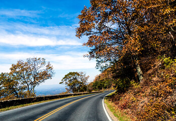 road trip on open road and highway traversing vibrant autumn woods