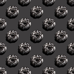 Seamless pattern with crumb baked donut on black background.