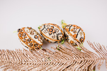 decorated easter eggs with feathers on a white background