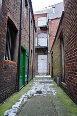 Narrow, old alleyway in the city during winter 