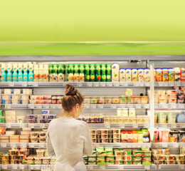 Woman choosing a dairy products at supermarket