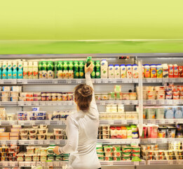 Woman choosing a dairy products at supermarket