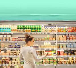 Woman choosing a dairy products at supermarket