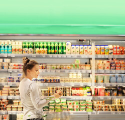 Woman choosing a dairy products at supermarket