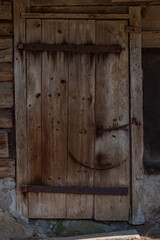 Old wooden door closed with cramps.