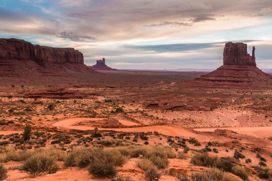 dramatic landscape photo of the spectacular mesa and buttes and rock formations in Monument Valley in the border of Utah and Arizona.