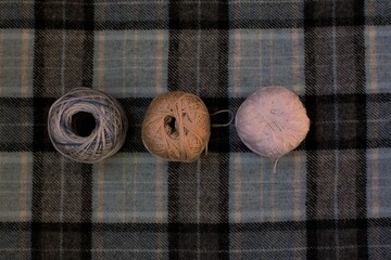 three skeins on wooden background