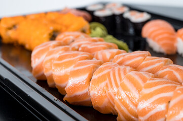 Close-up of fresh rolls and sushi set. Japanese cuisine. Tasty food. Fish and rice.