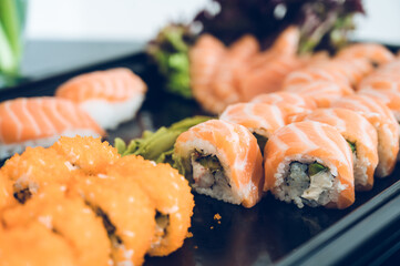 Close-up of fresh rolls and sushi set. Japanese cuisine. Tasty food. Fish and rice.