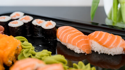 Close-up of fresh rolls and sushi set. Japanese cuisine. Tasty food. Fish and rice.
