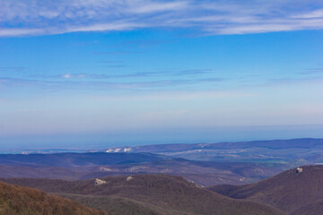 clouds, blue sky, haze over the mountains.