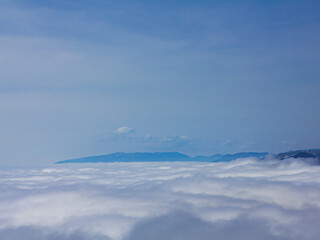 Fototapeta na wymiar clouds, blue sky, haze over the mountains.