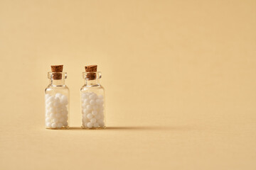 Two bottles of homeopathic remedies with copy space