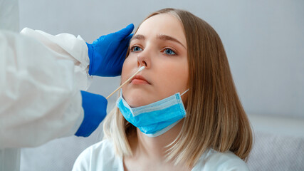 Doctor taking PCR test nasopharyngeal culture to woman patient. Nurse take saliva sample through nose with cotton swab check coronavirus covid 19 test. Diagnostics testing patients. Long web banner