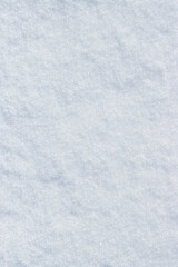 Natural snow texture. Smooth surface of clean fresh snow. Snowy ground. Winter background with snow patterns. Perfect for Christmas and New Year design. Closeup top view.