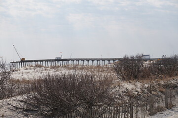 Crane Repairing Fishing Pier at the Beach