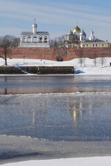 Novgorod Kremlin.Veliky Novgorod, Russia.St. Sophia Cathedral and belfry.Winter view with reflection in the water and ice of the Volkhov River
