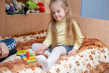 Harmonious development of a child with down syndrome. Music therapy for children with down...