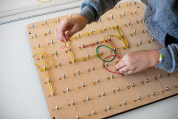 Exploring basic math and geometry concepts with geoboard
