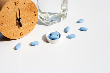 PrEP ( Pre-Exposure Prophylaxis) used to prevent HIV with wooden clock and glass of water
