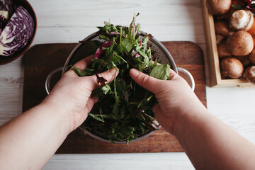 Clean healthy detox eating. Vegan, vegetarian food. Female hands making healthy vegetable salad.
