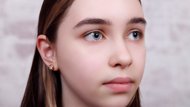 young cute girl with big light blue eyes, focus on the right eye