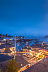 Obraz premium USA, Maine, Camden. Elevated view of Camden Harbor and harborside motel at dusk.