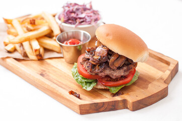 beef burger with mushrooms and onions and french fries
