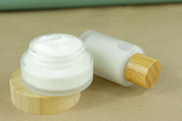 Moisturizing cream in eco-friendly bamboo jar. Natural organic cosmetic packaging design. Hand skin care concept.