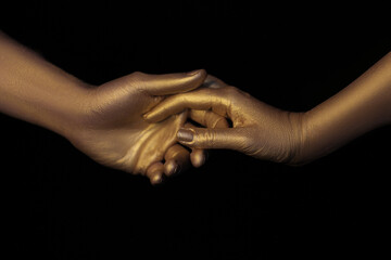 hands covered with gold steam paint. Hands of lovers. Hands in gold. Love